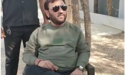 kirtidan gadhvi seating outside booth as he was not allowed to vote