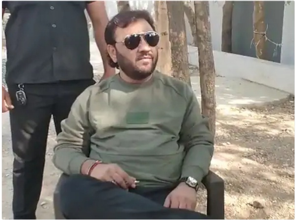 kirtidan gadhvi seating outside booth as he was not allowed to vote