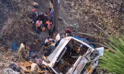 A bus carrying 65 passengers went down a highway in Gujarat, killing two children and injuring eight others.